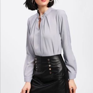Super cute silky blouse with metal button front.